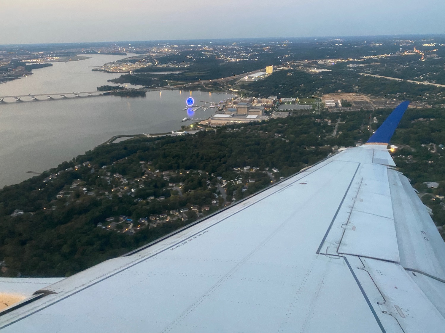 an airplane wing and a body of water