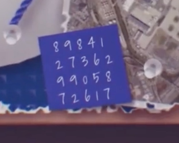 a blue square note with white numbers on it