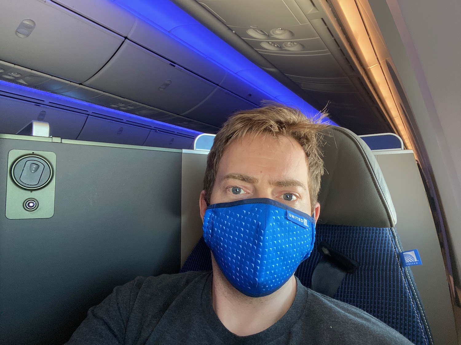 a man wearing a blue face mask