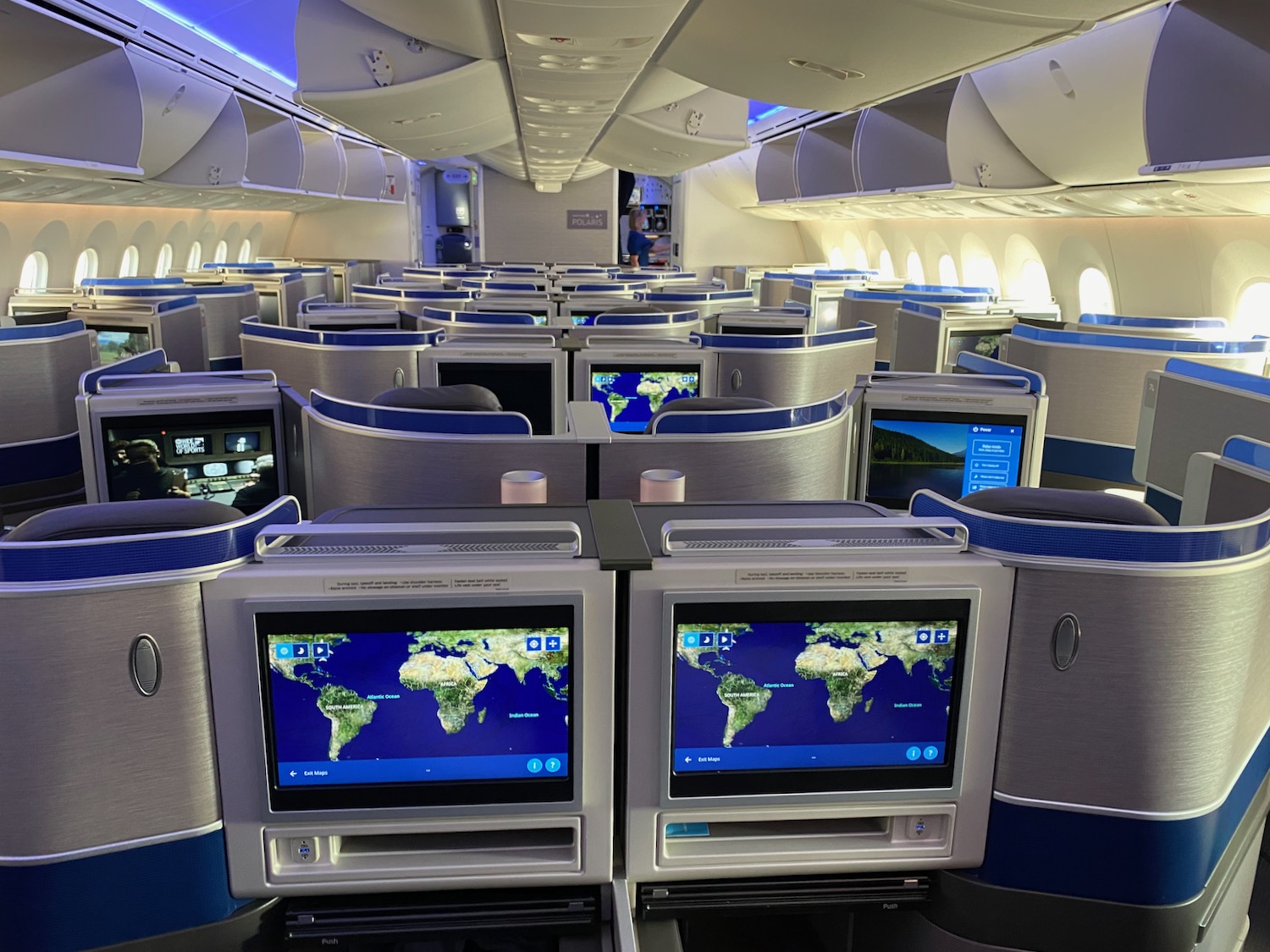 a row of monitors on an airplane