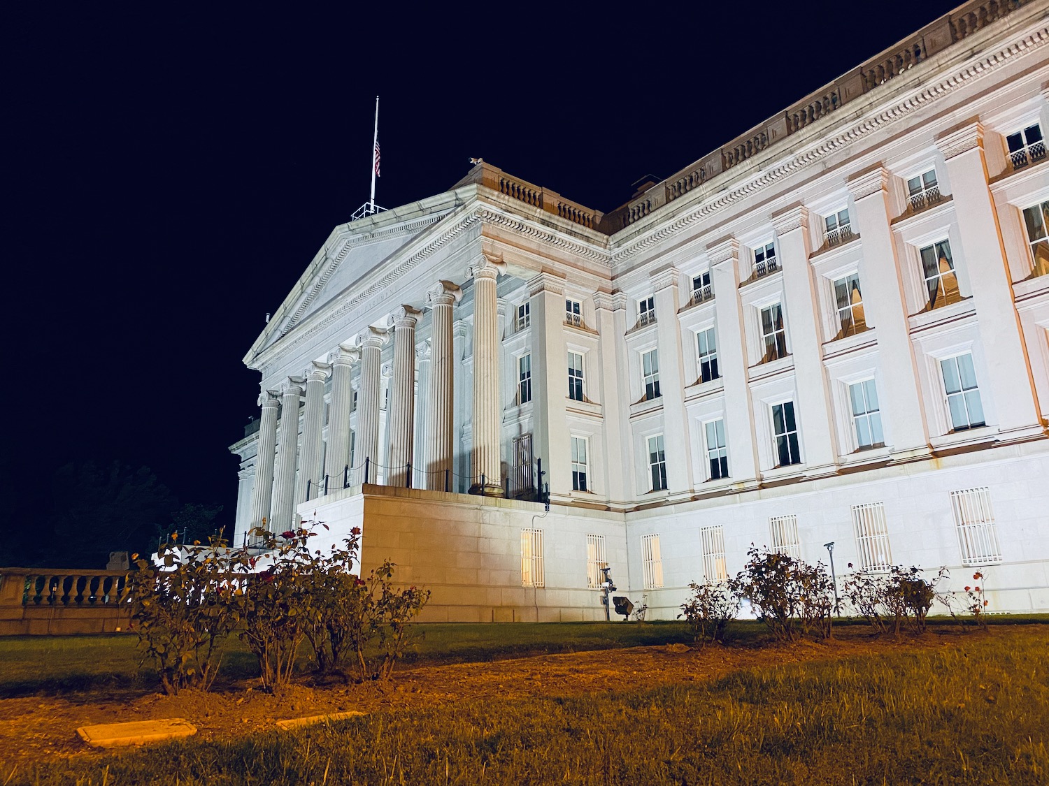 a white building with columns at night
