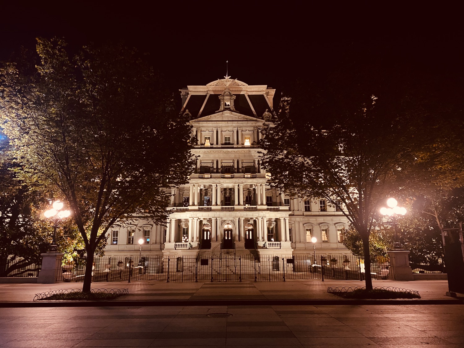 a large white building with trees around it