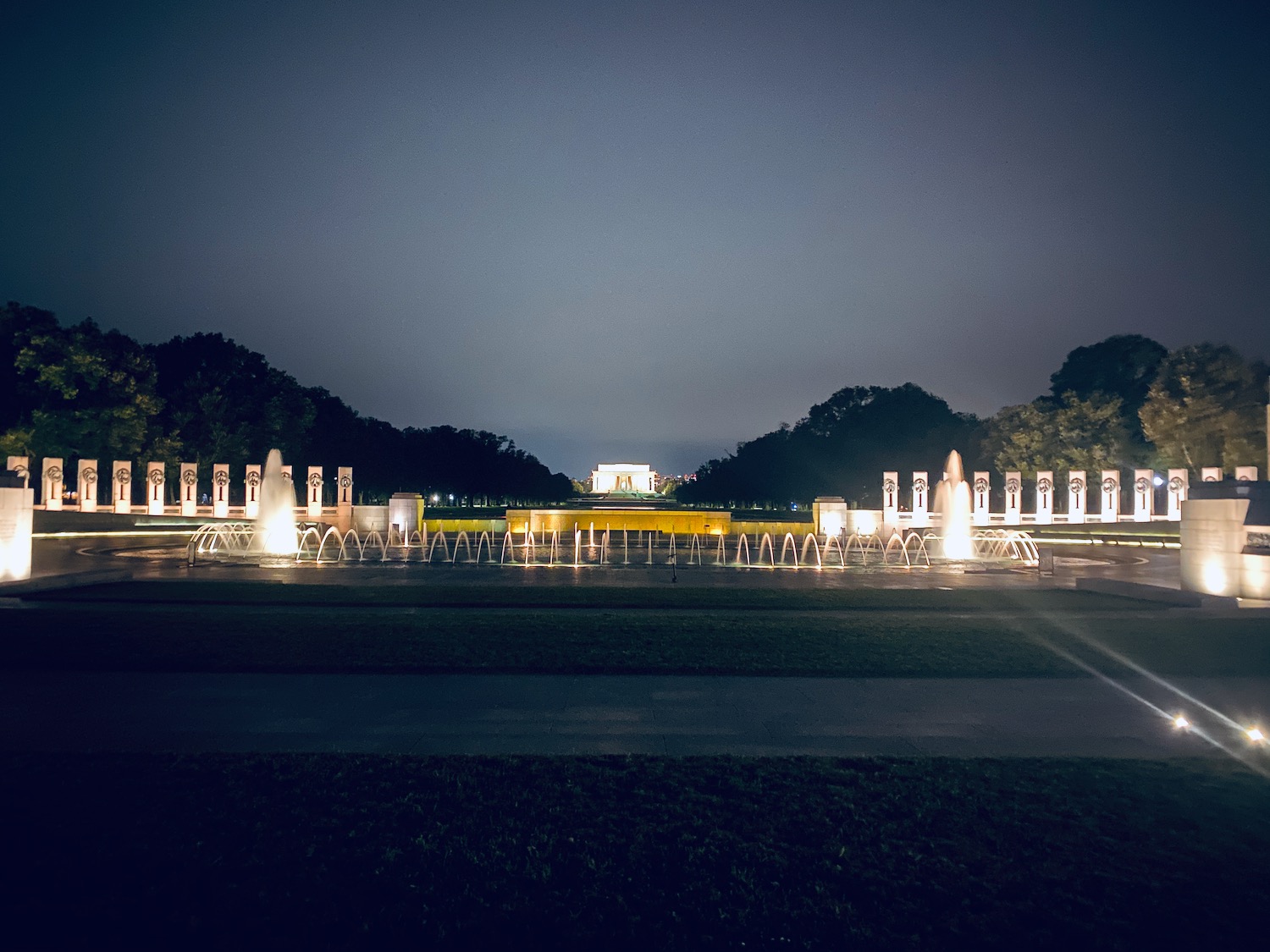 a water fountain with lights at night