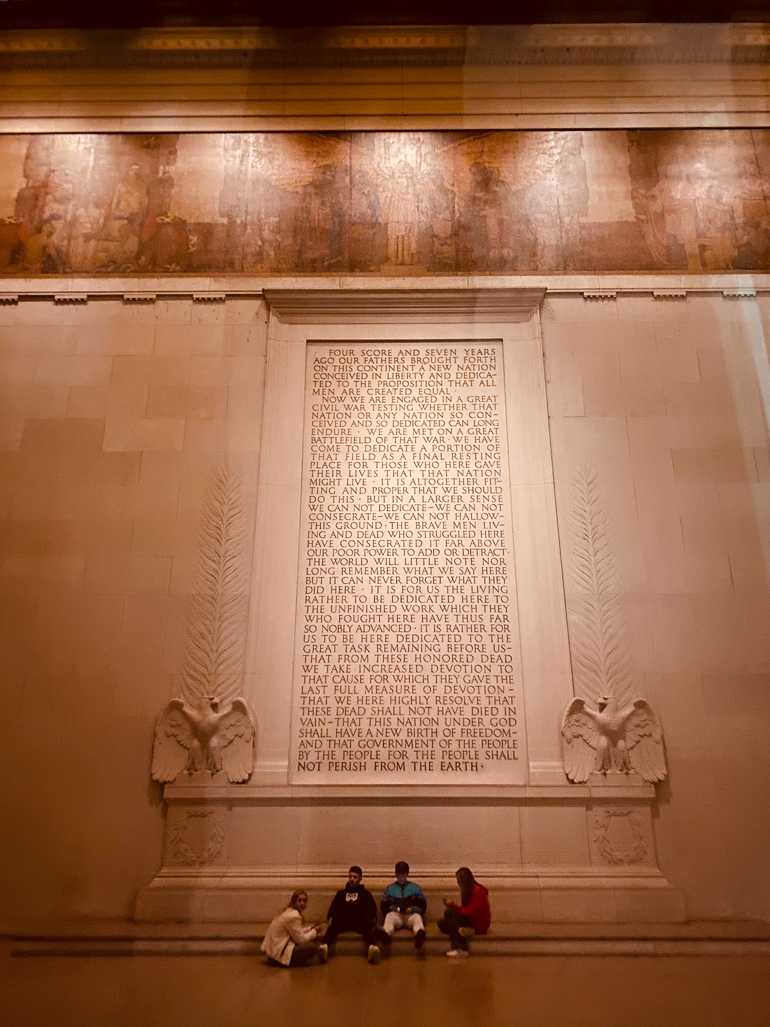 a wall with a large carved panel with text on it