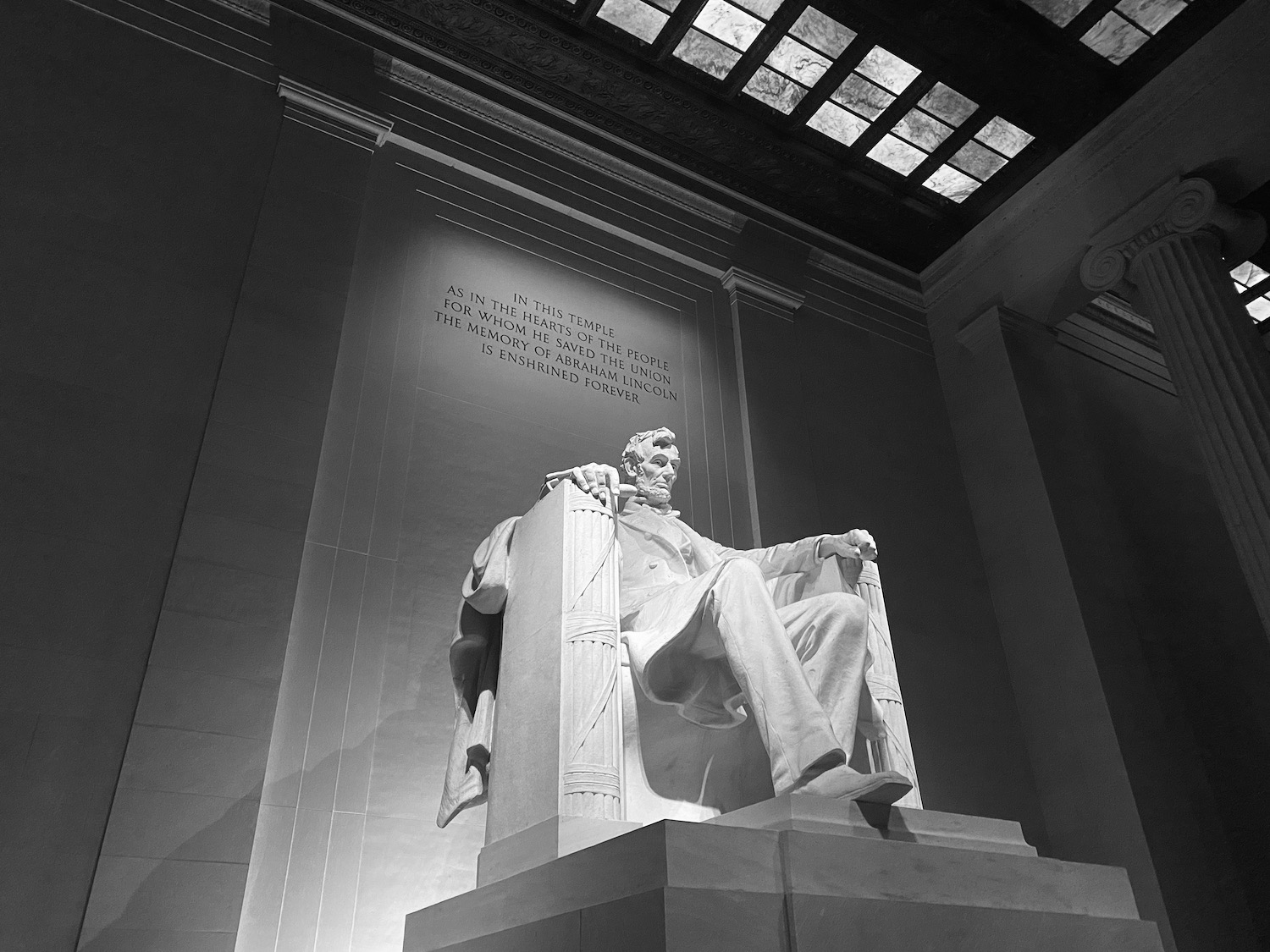 a statue of a man sitting in a chair