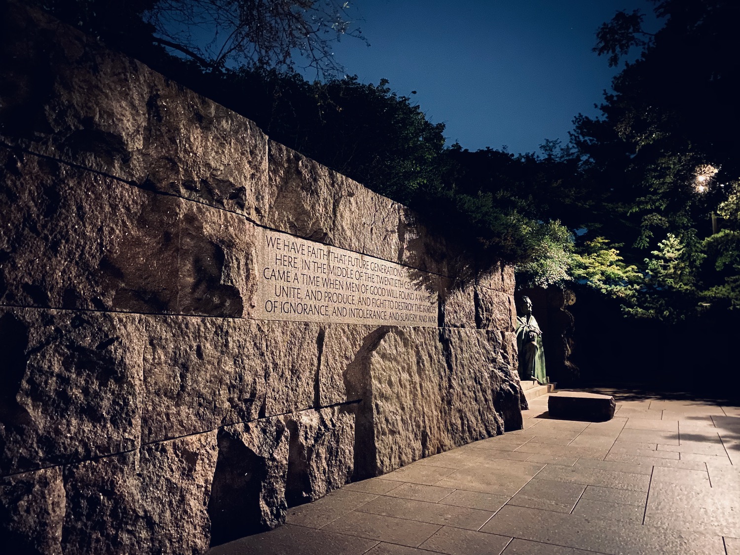 a stone wall with a statue on it