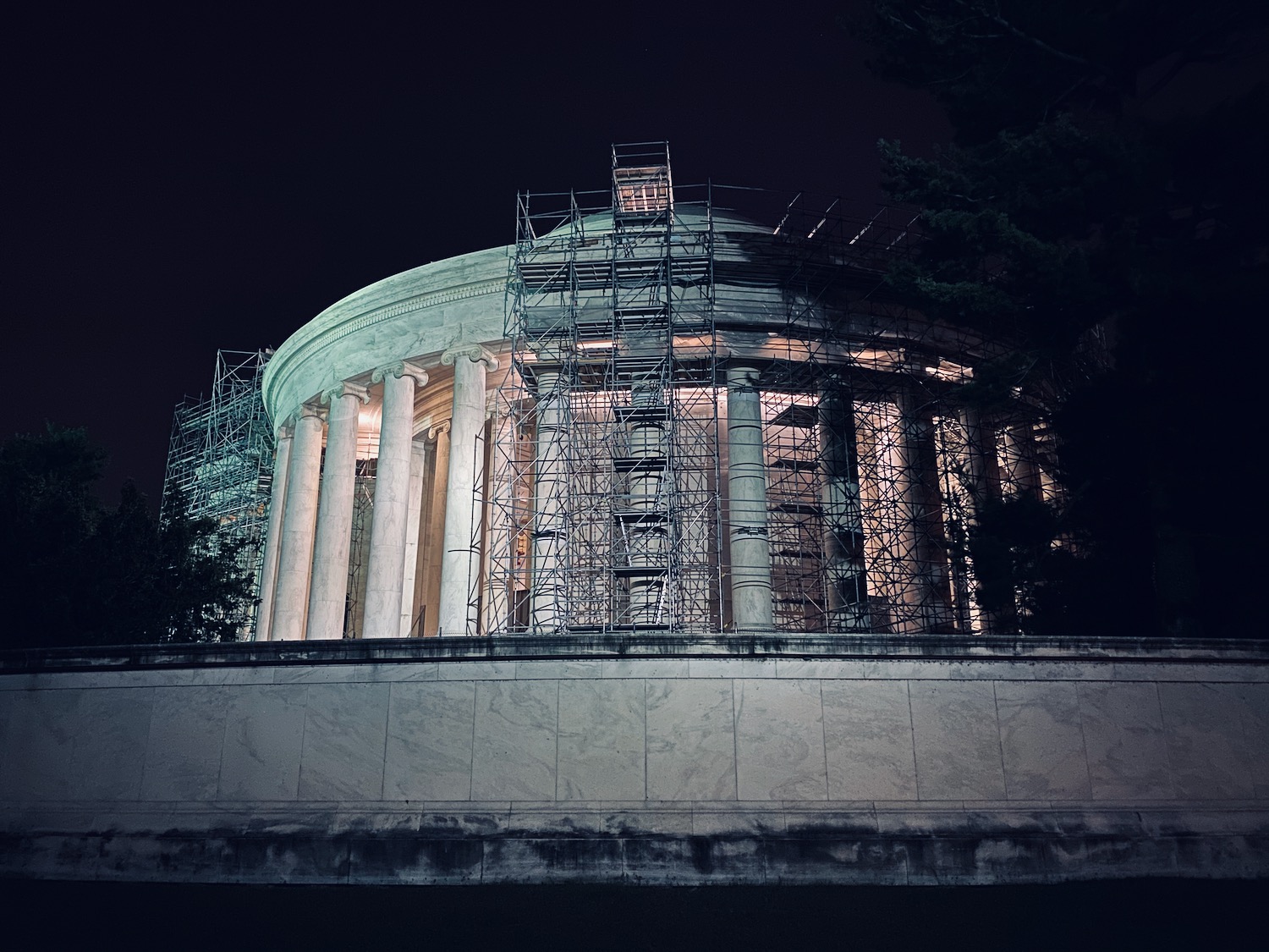 a building with pillars and scaffolding