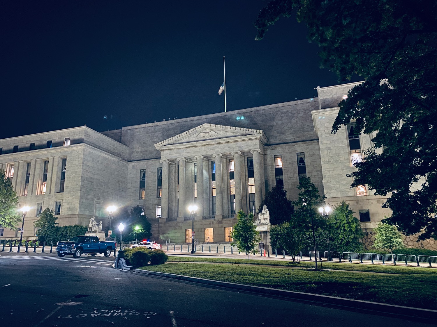 a building with columns and a flag pole