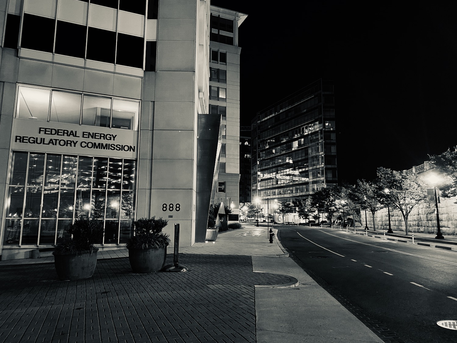 a street with a building and trees