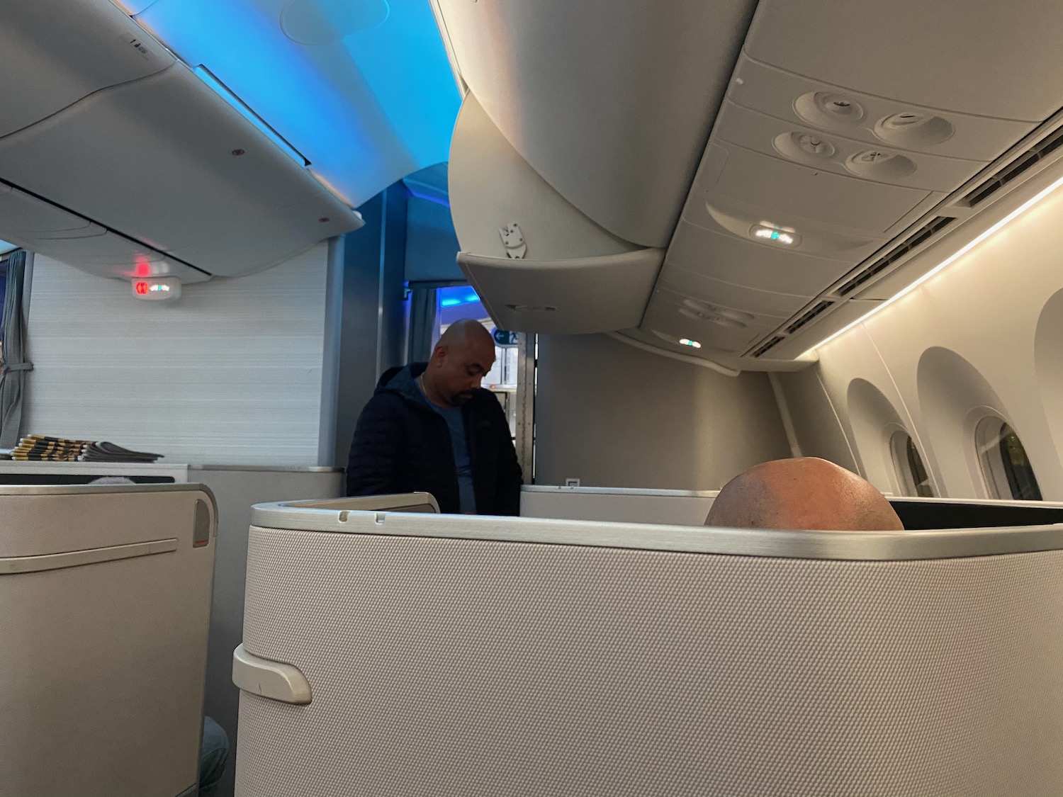 a man standing in a chair in an airplane