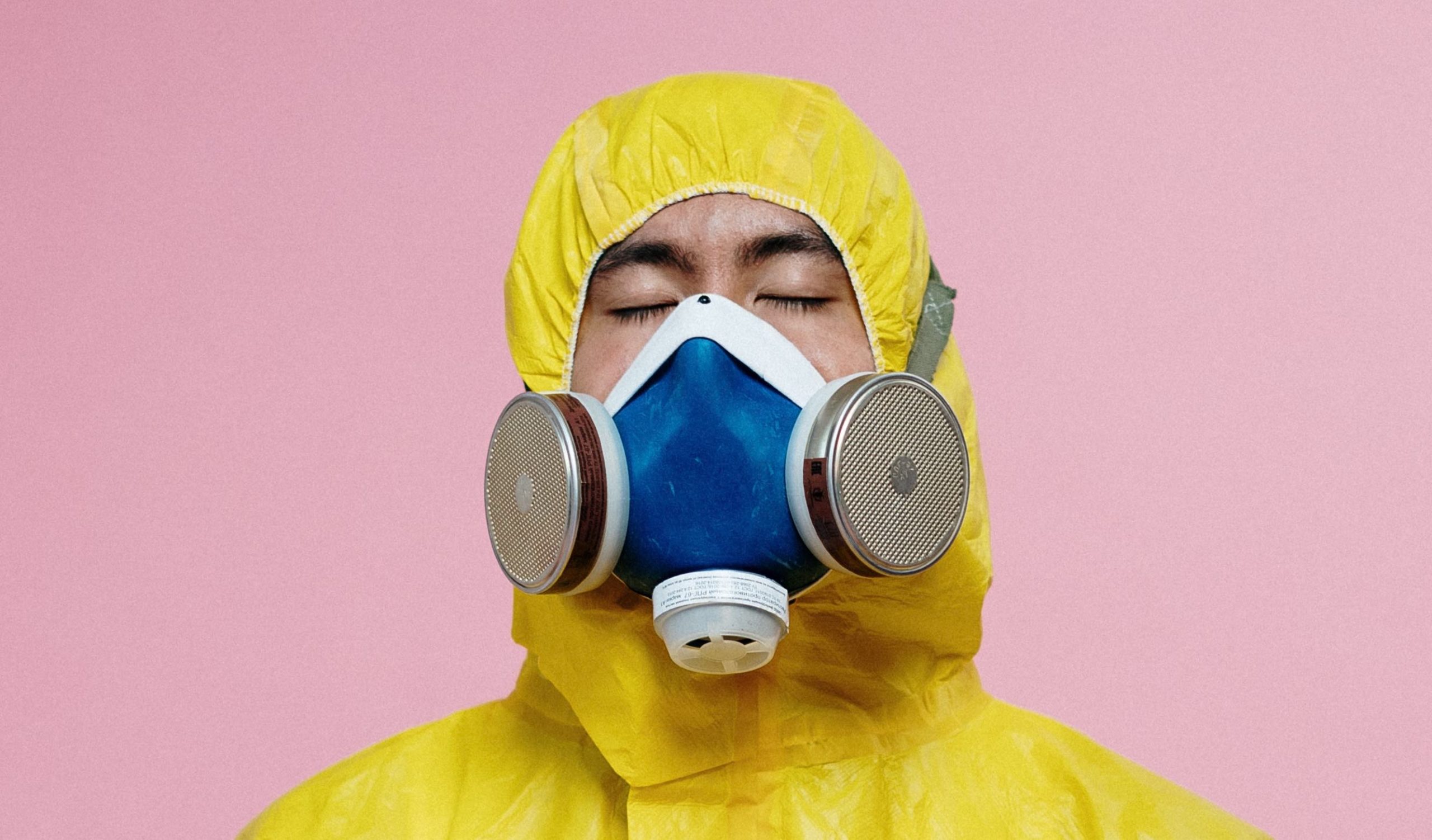 a person wearing a yellow raincoat and a gas mask