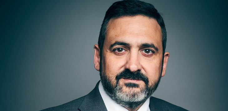 a man with a beard and mustache wearing a suit and tie