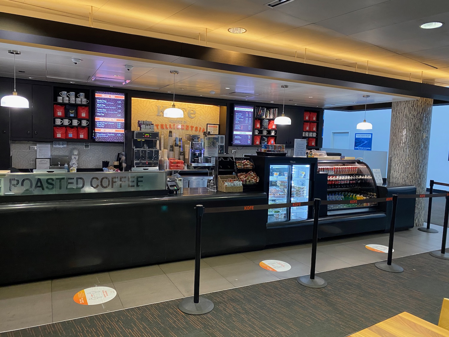 a coffee shop with a counter and a sign