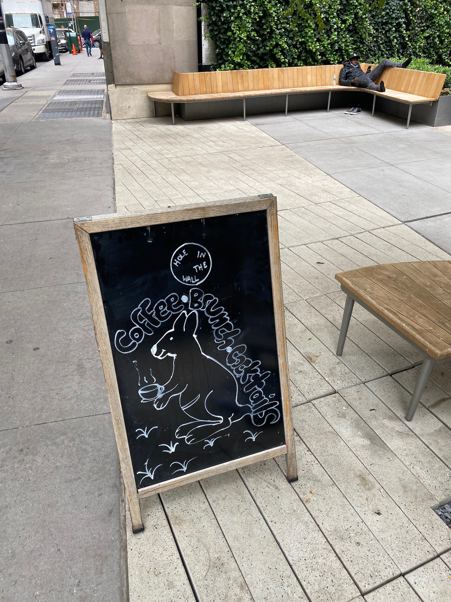 a chalkboard sign on a sidewalk
