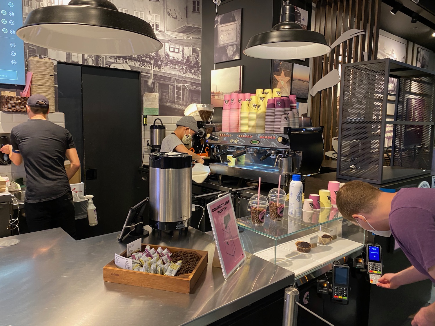 a coffee shop with a counter and people