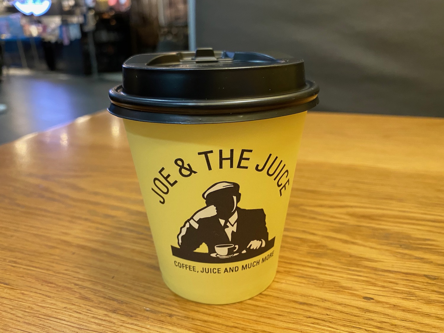 a yellow coffee cup on a table