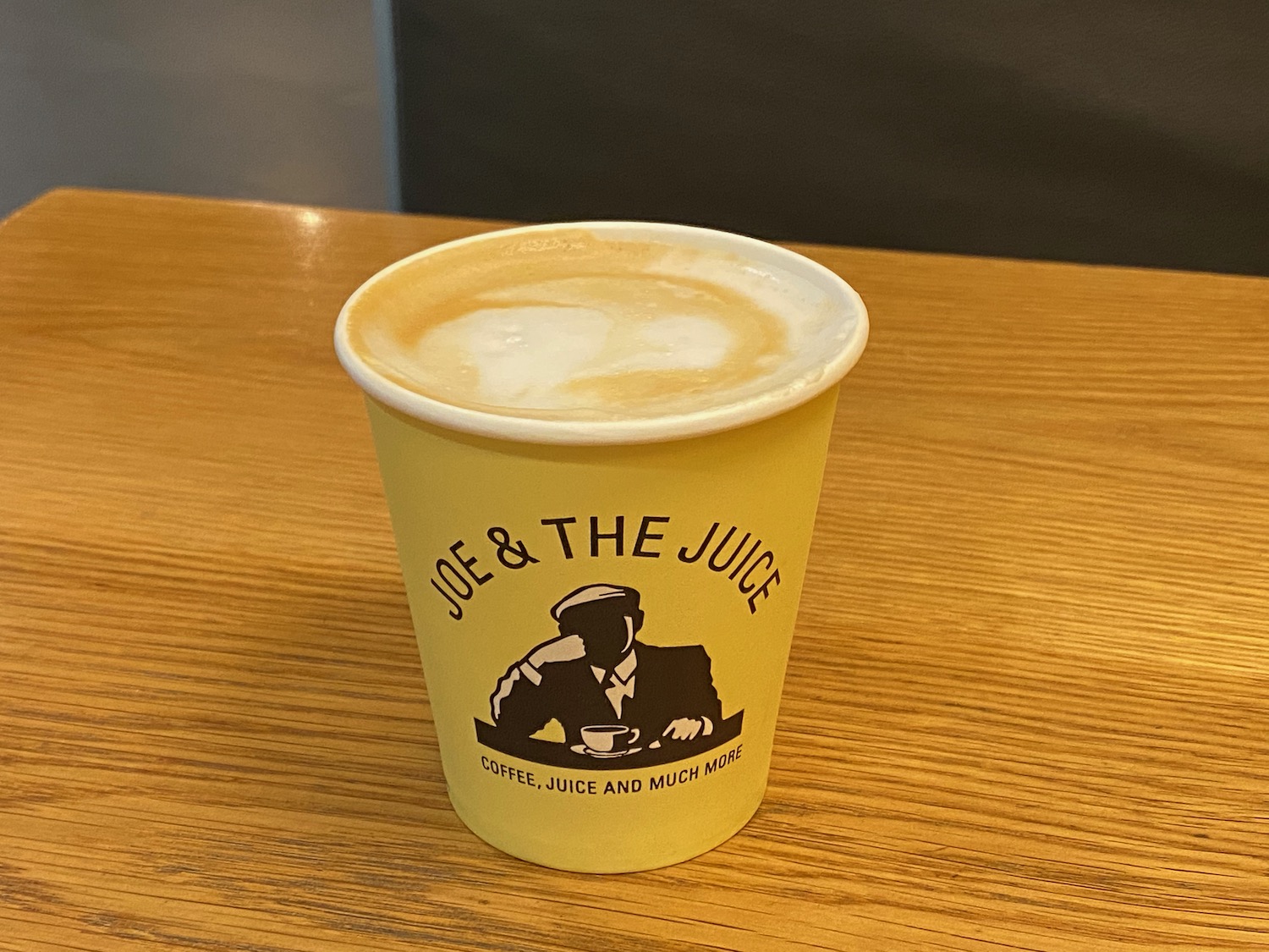 a yellow cup of coffee on a table