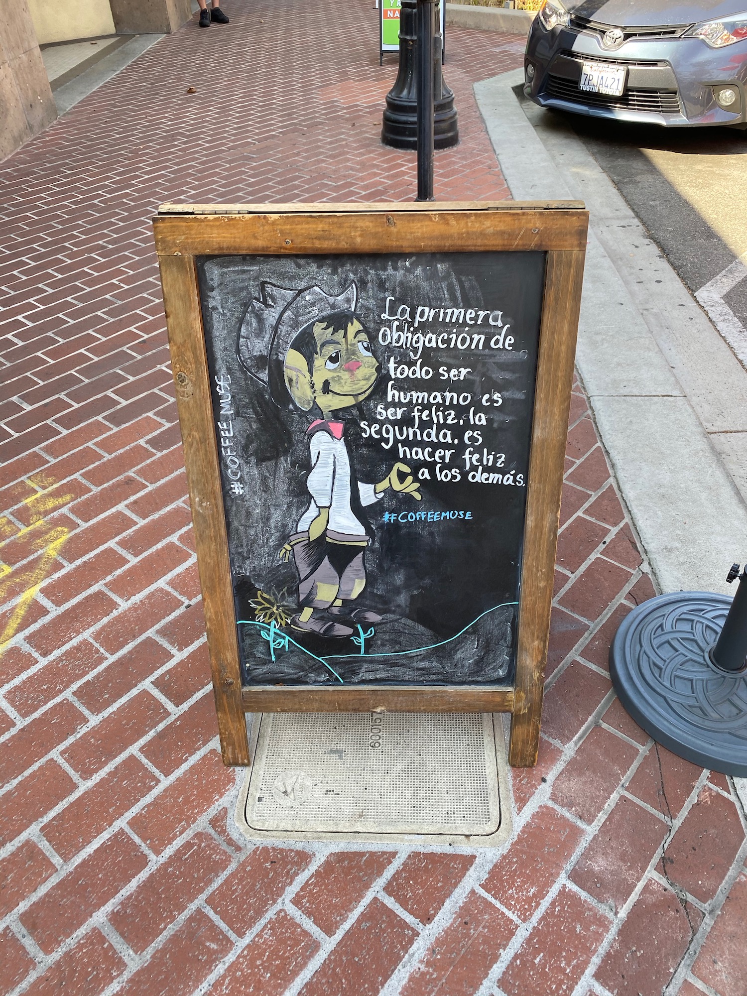 a chalkboard sign on a sidewalk