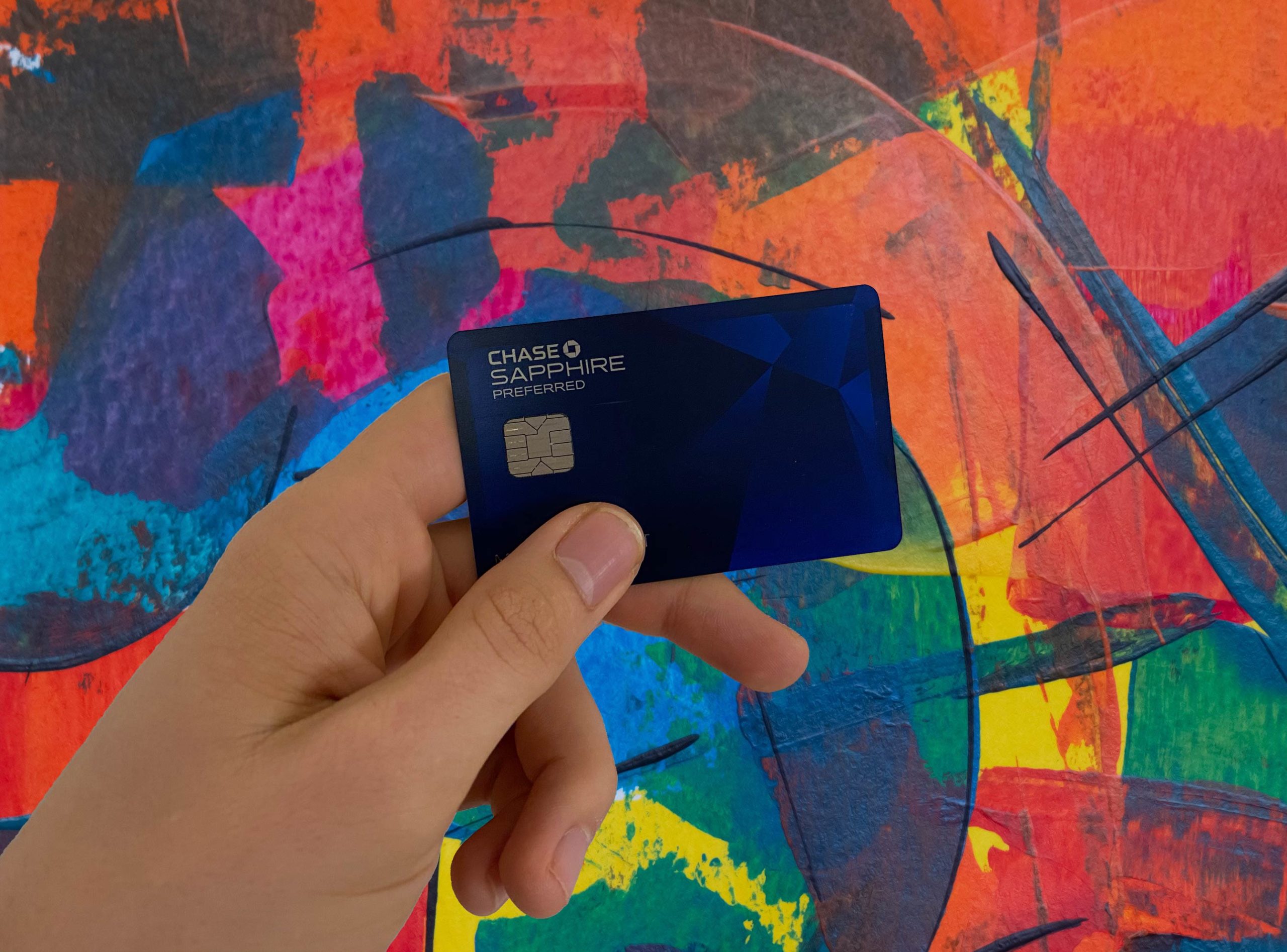 a hand holding a blue card