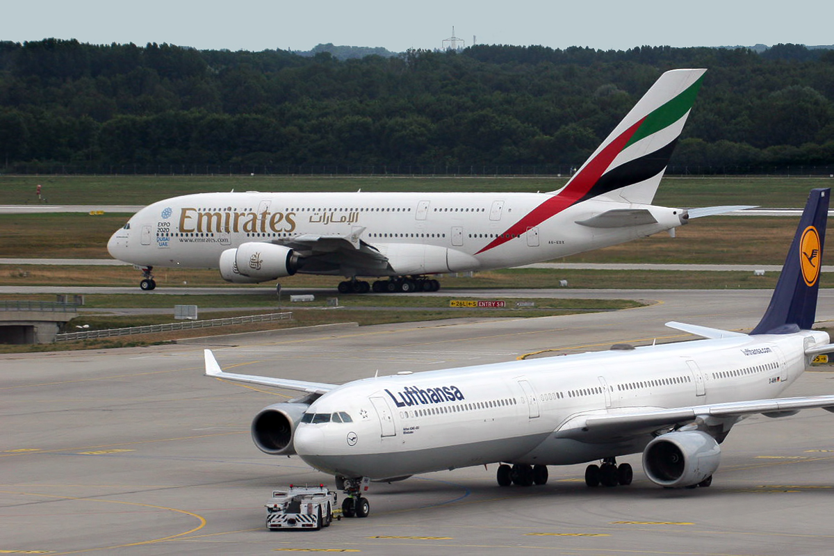 a group of airplanes on a runway