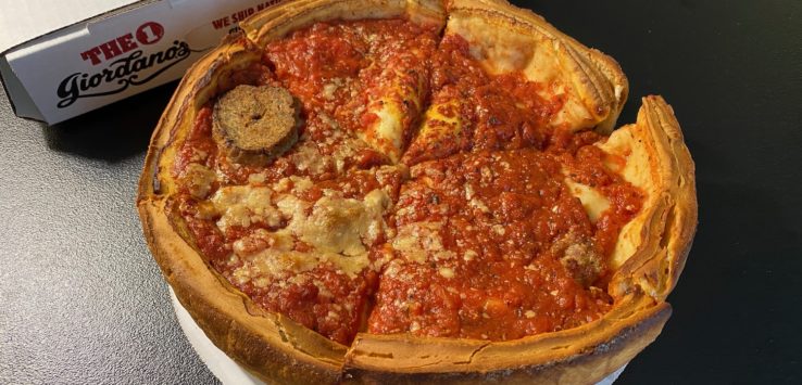 a deep dish pizza with a slice of pizza in it