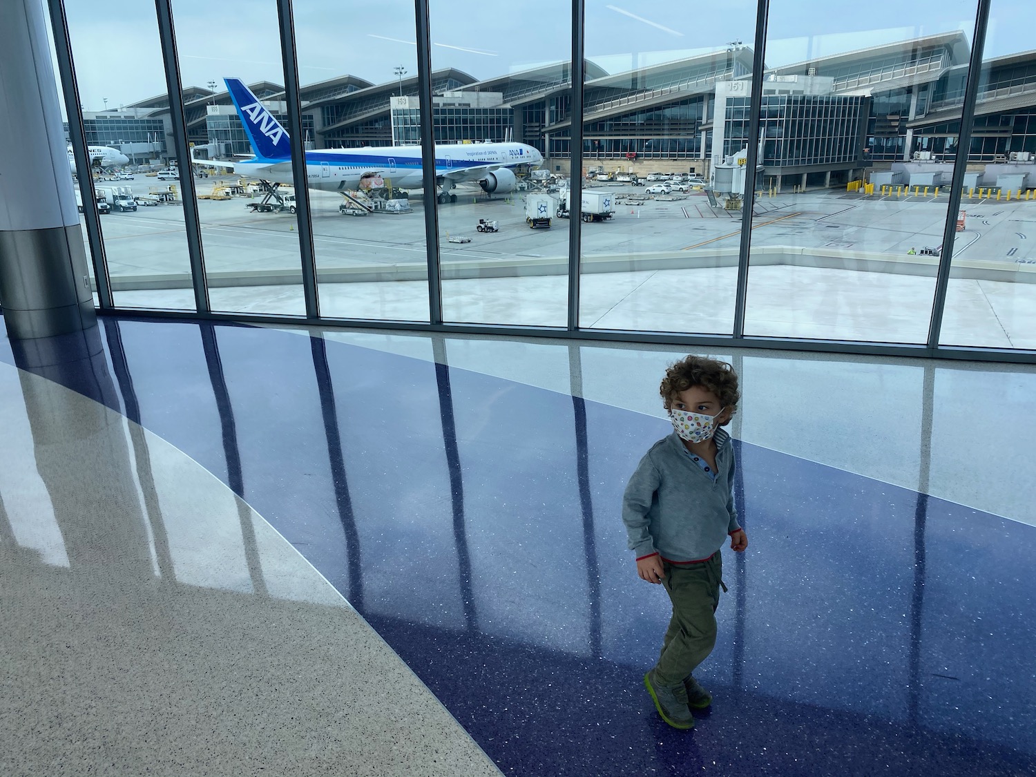 a child wearing a mask in an airport
