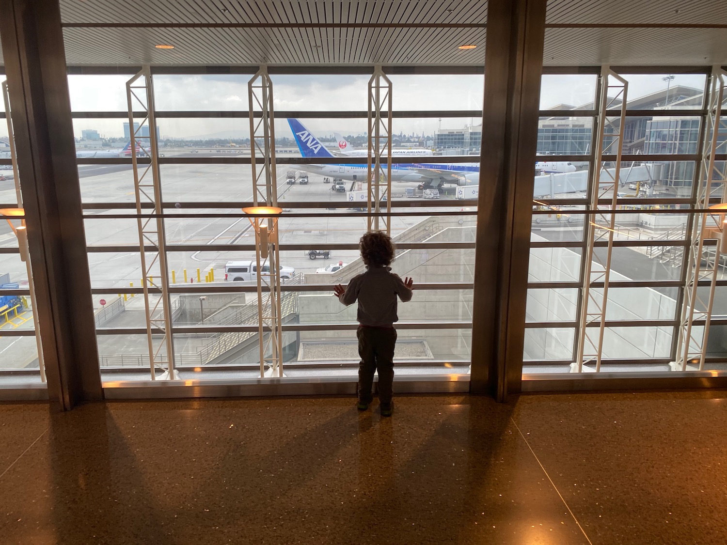 a child standing in front of a window