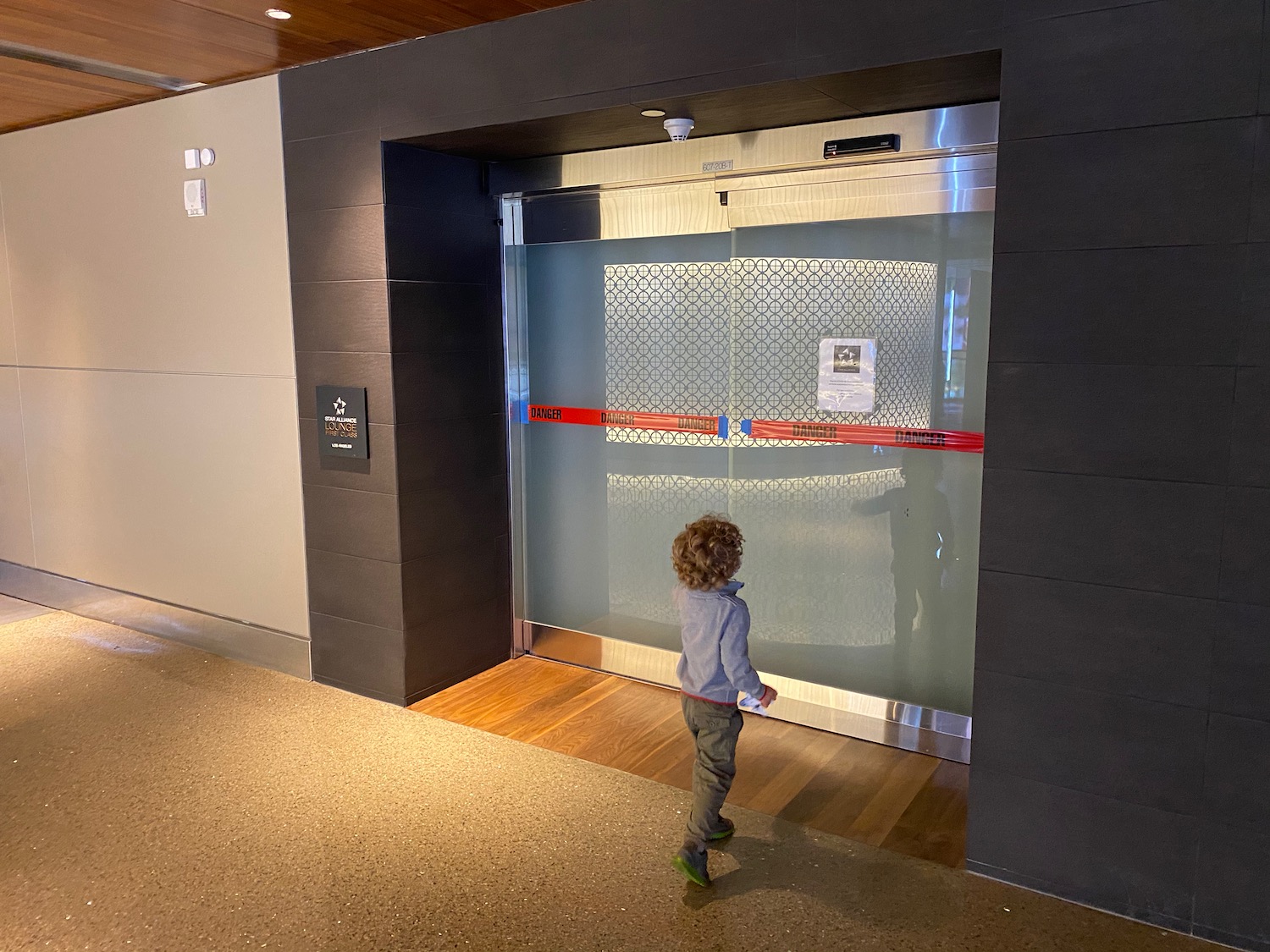 a child standing in a glass elevator