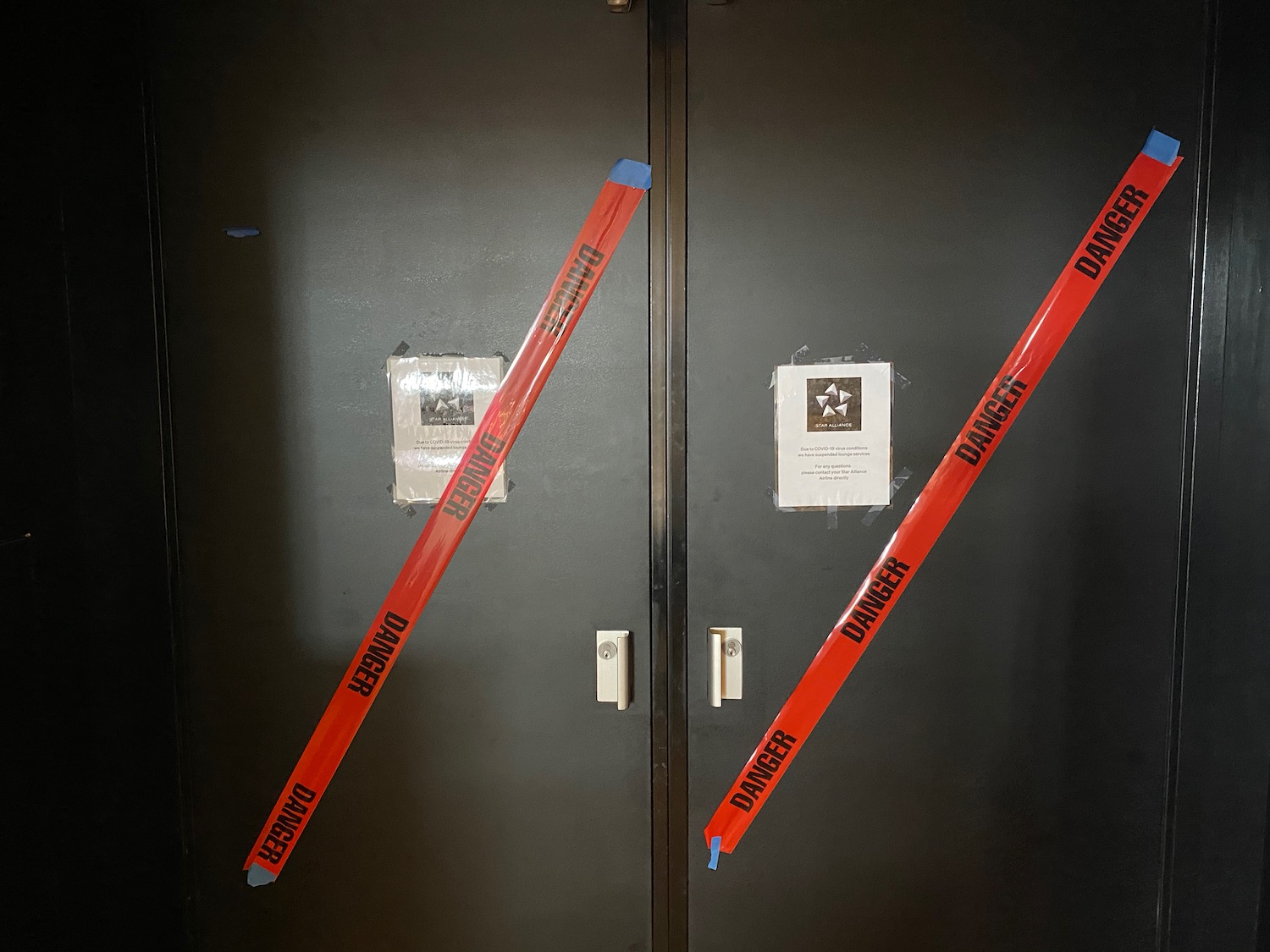 a black double doors with red tape on them