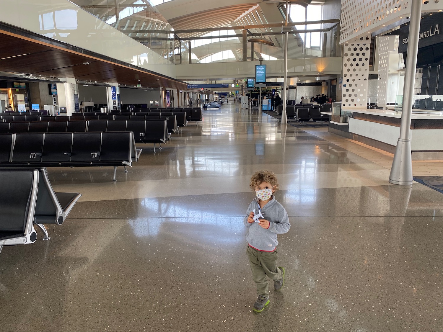 a child wearing a mask in an airport