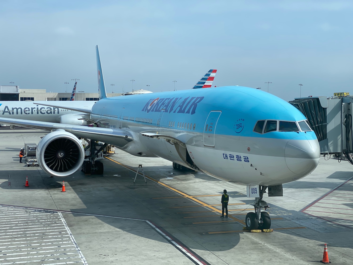 a blue and white airplane on a runway