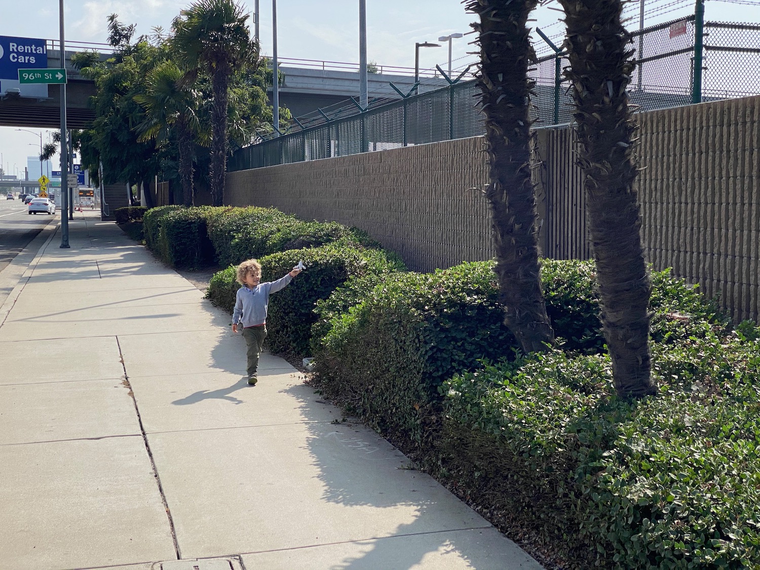 a child walking on a sidewalk