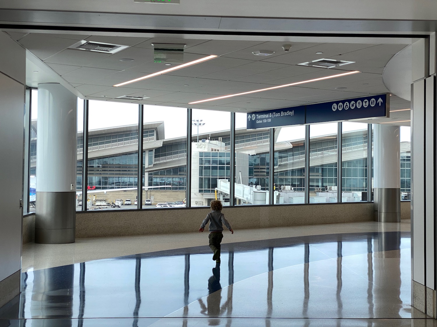 a child walking through a large glass room