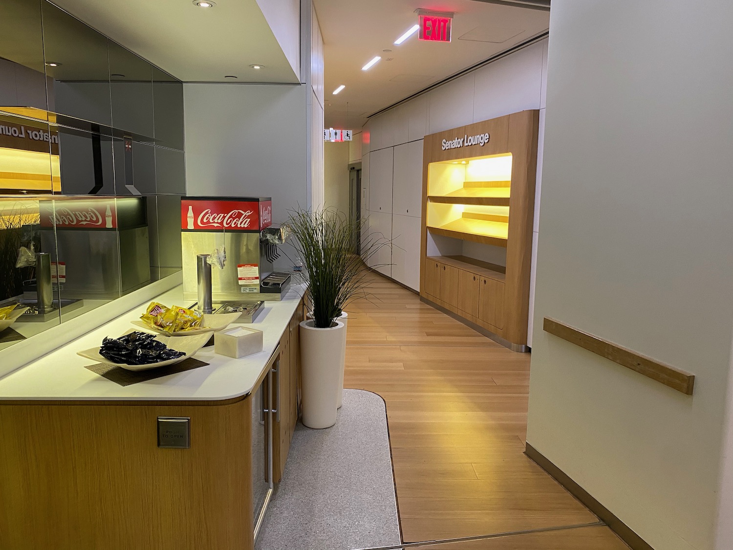 a hallway with a counter and a plant in front of it