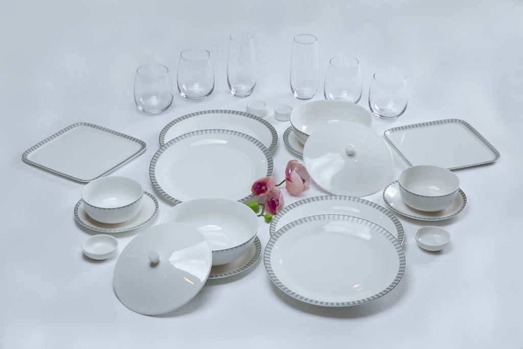 a group of white plates and glasses