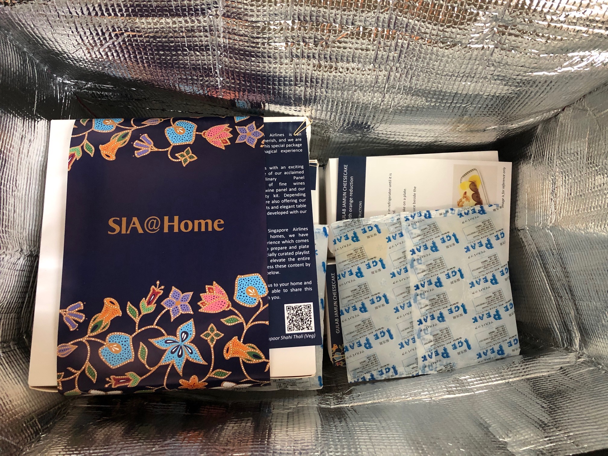 a box with a blue and gold object with flowers and a blue cover