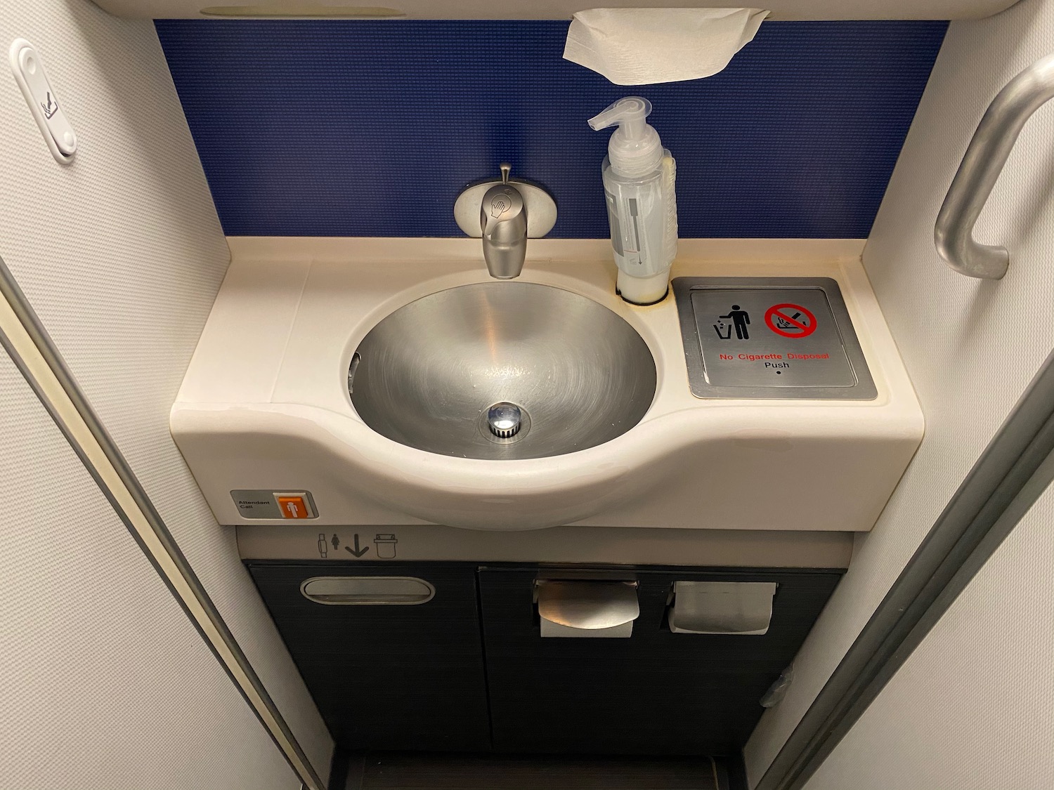 a sink with a bottle of liquid on it