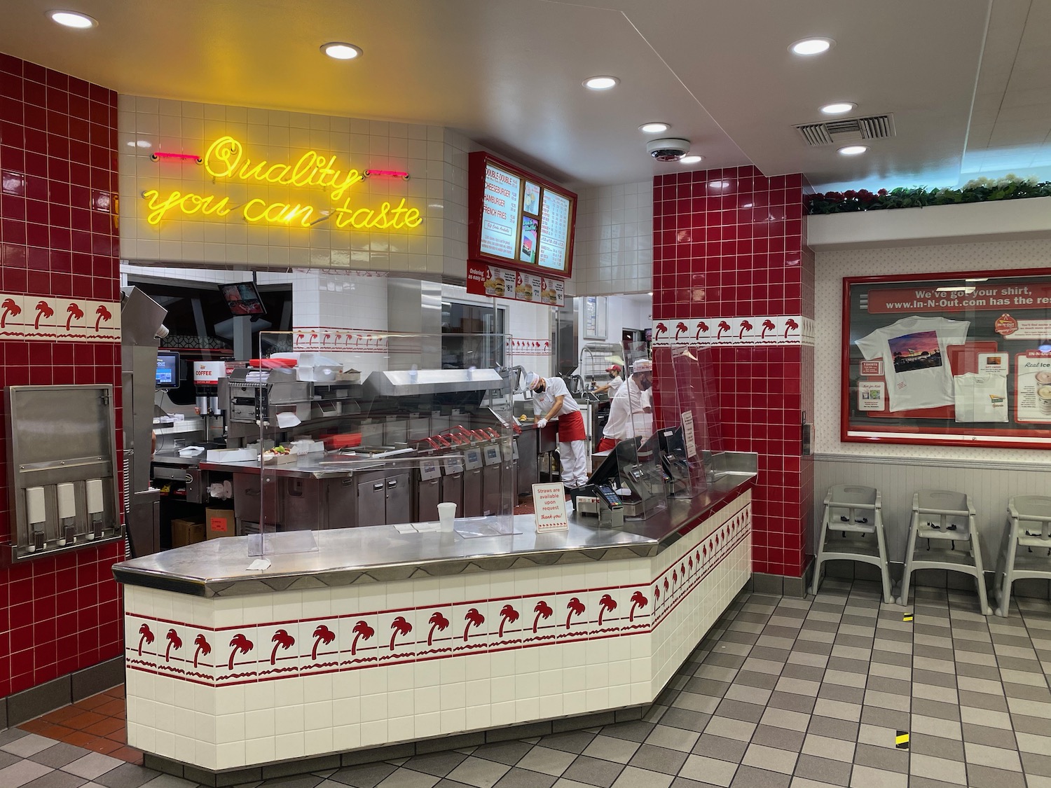 a restaurant with a counter and people in it