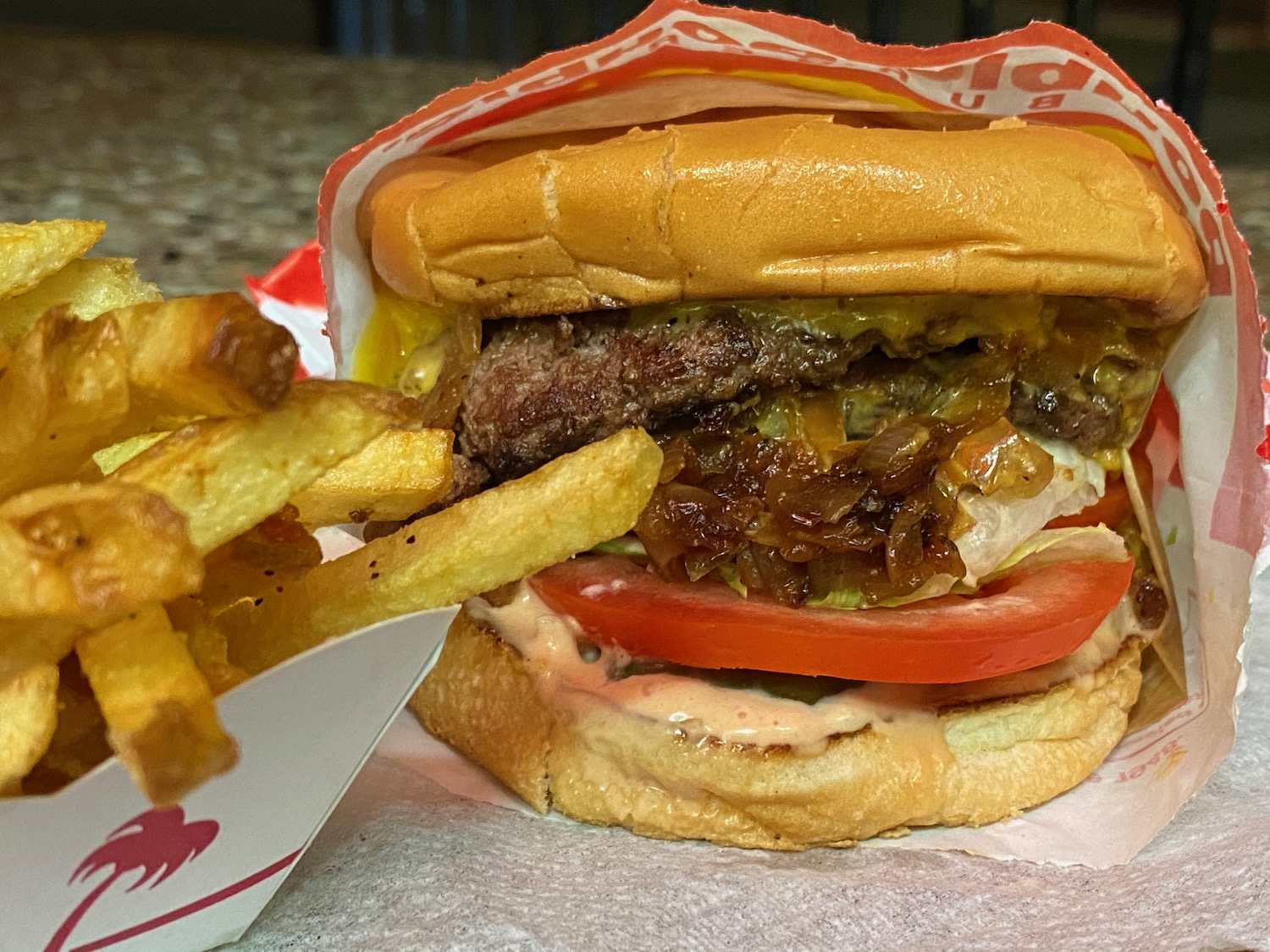 a burger and fries on a paper tray