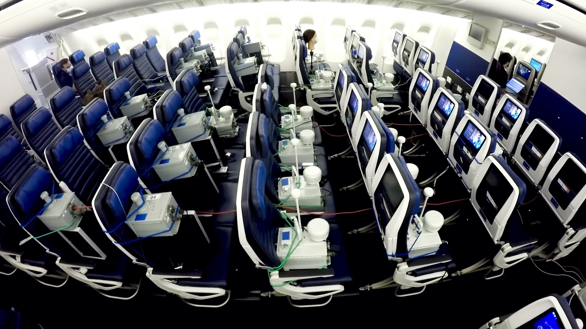 a room with rows of chairs and monitors