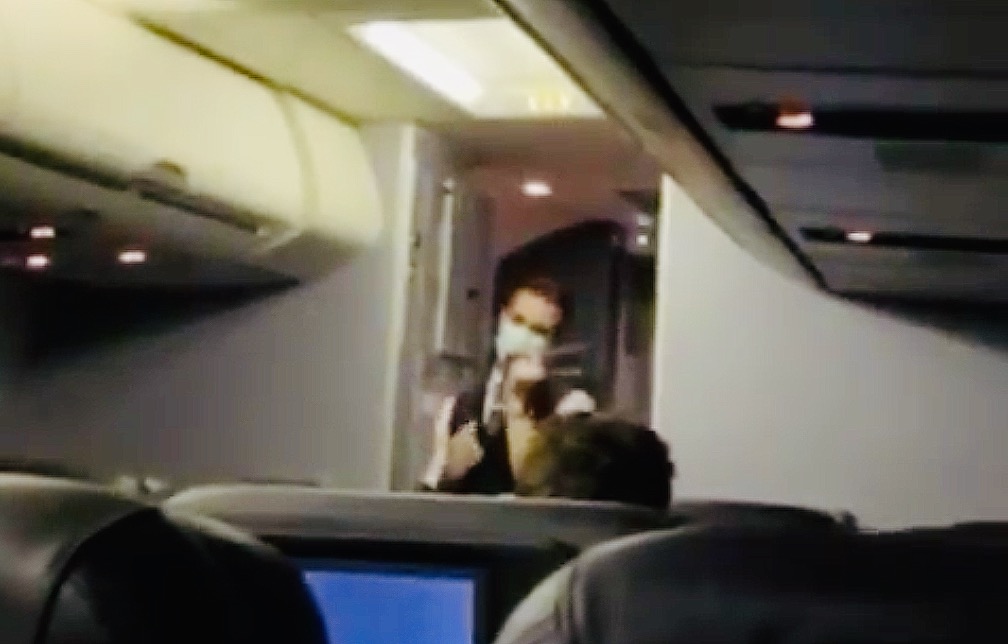 a person in a mask on an airplane