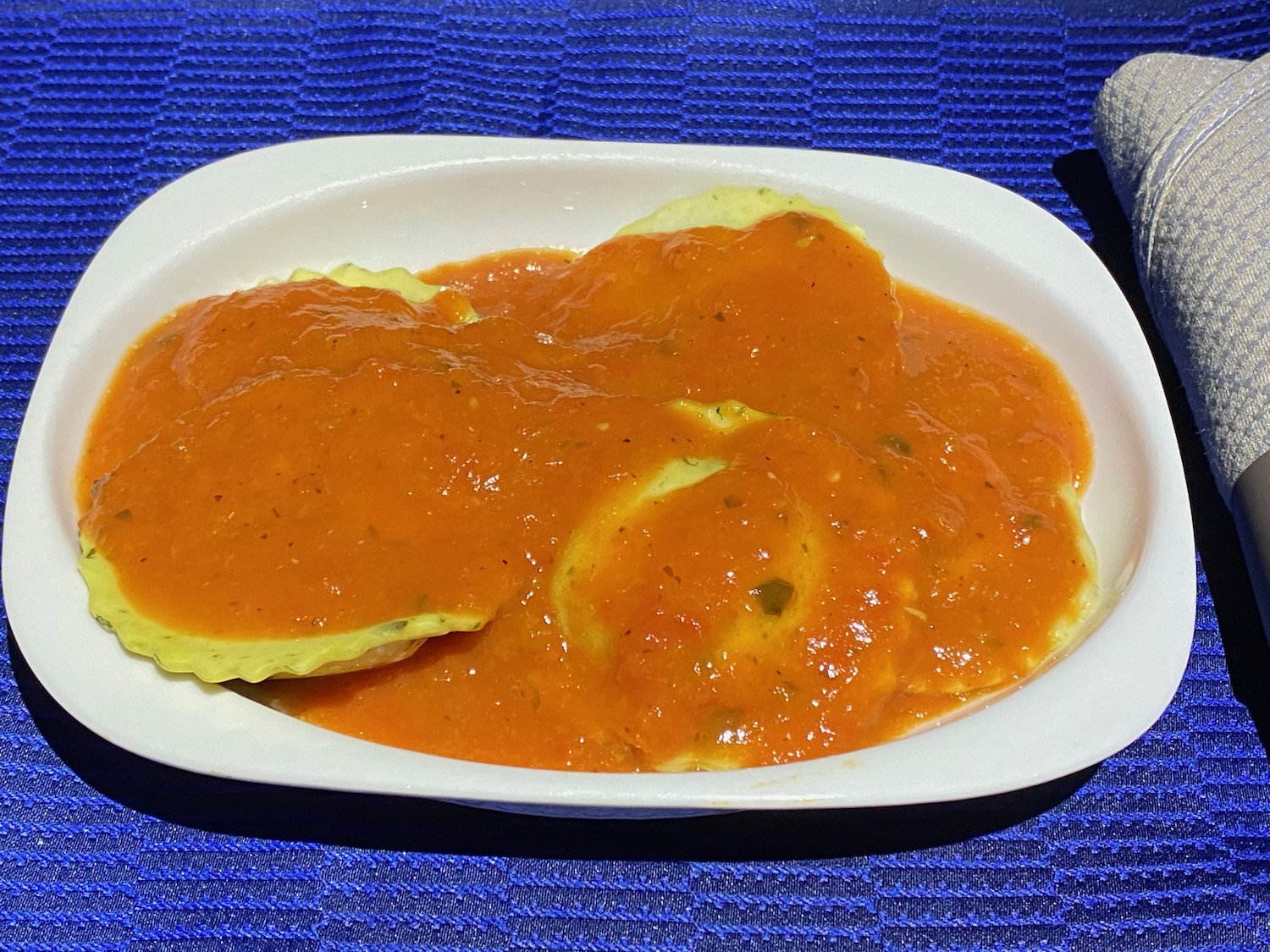 a plate of food on a blue place mat