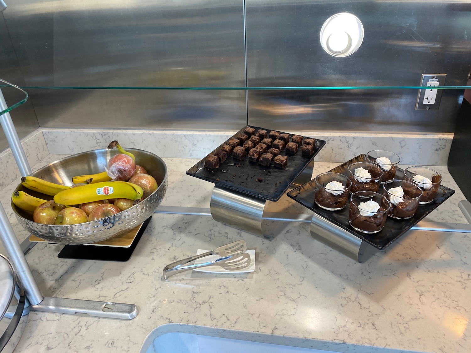 a group of desserts and fruit on a counter