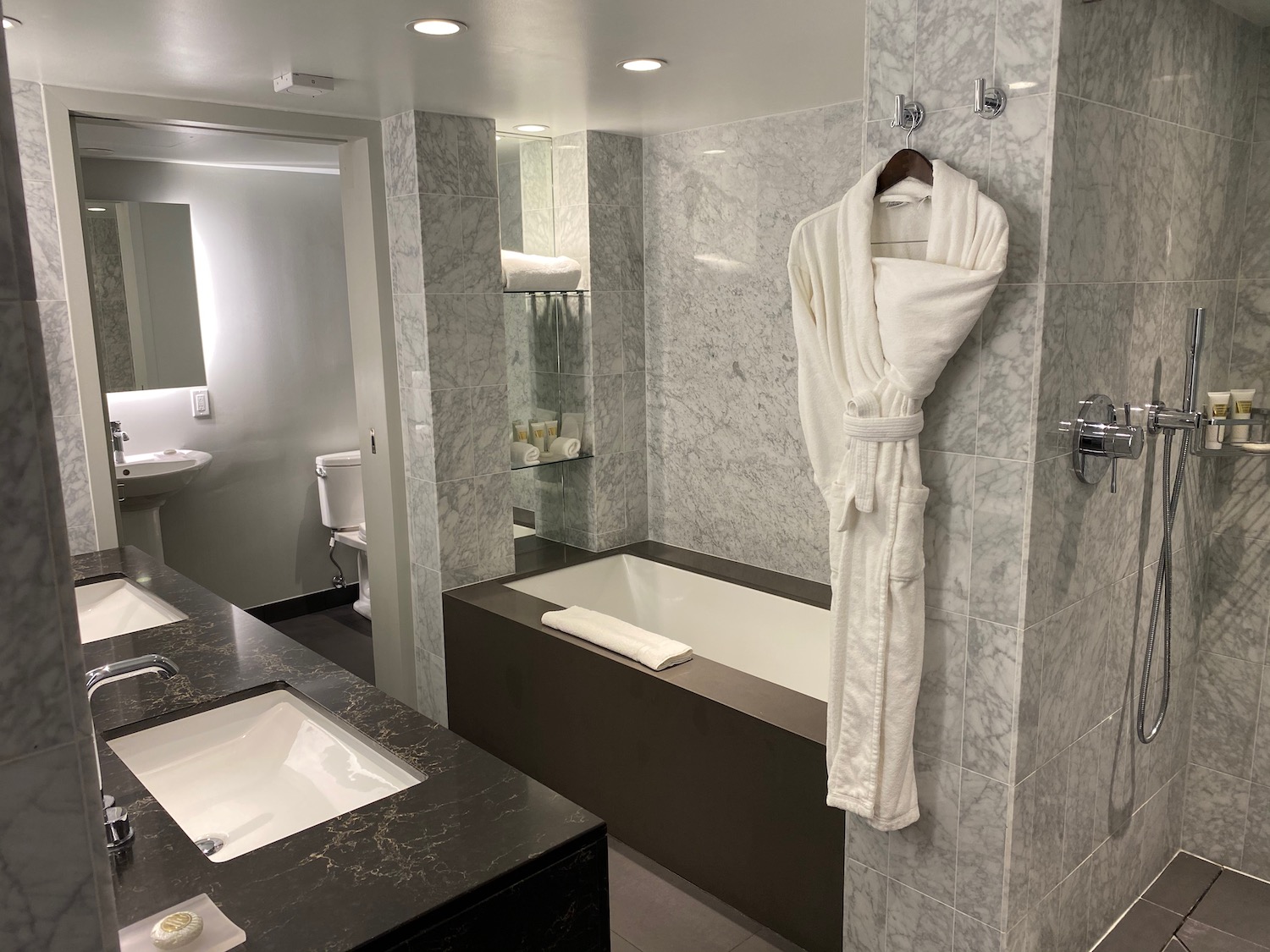 a bathroom with a bathrobe and tub