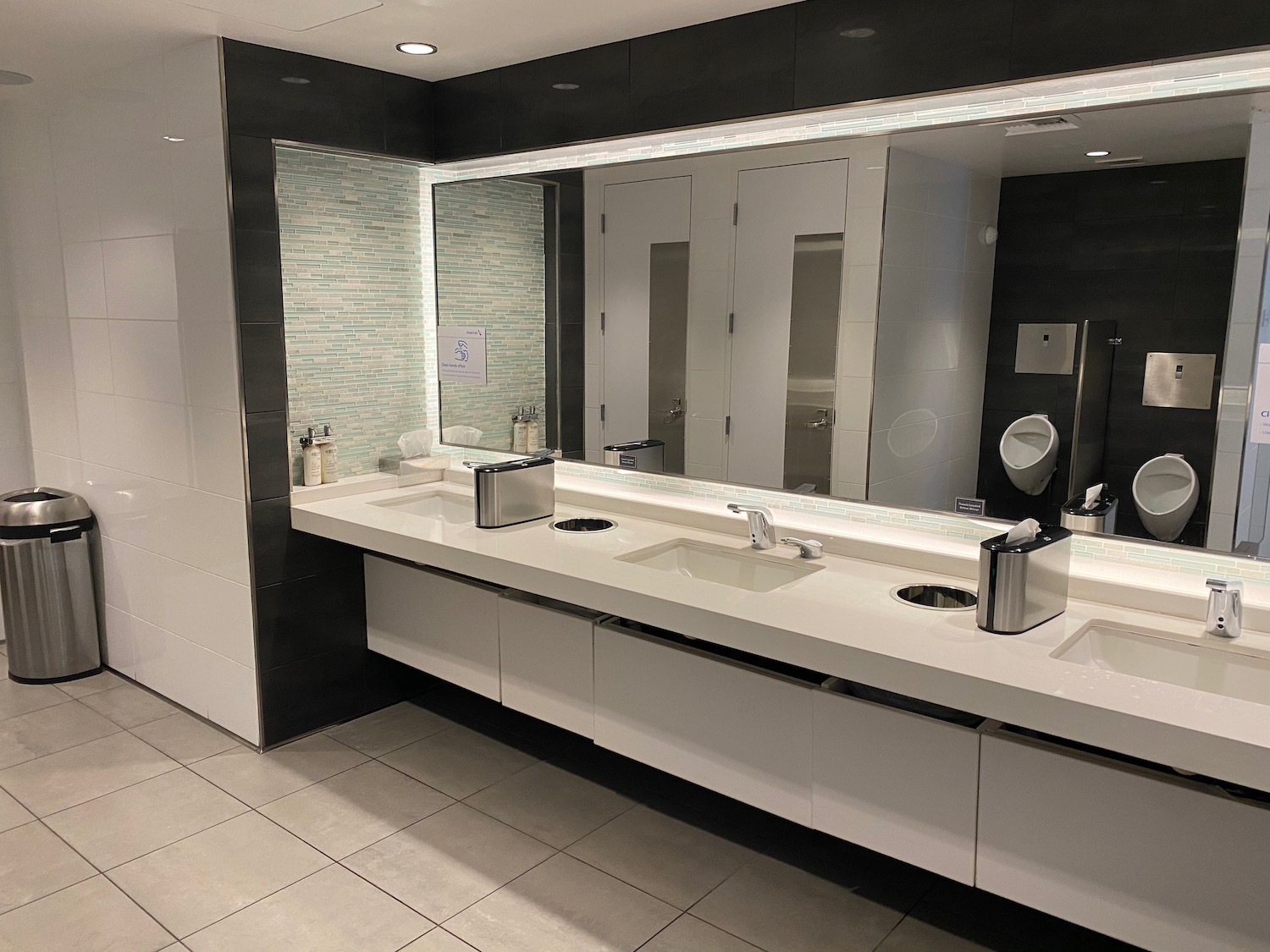 a bathroom with sinks and mirrors