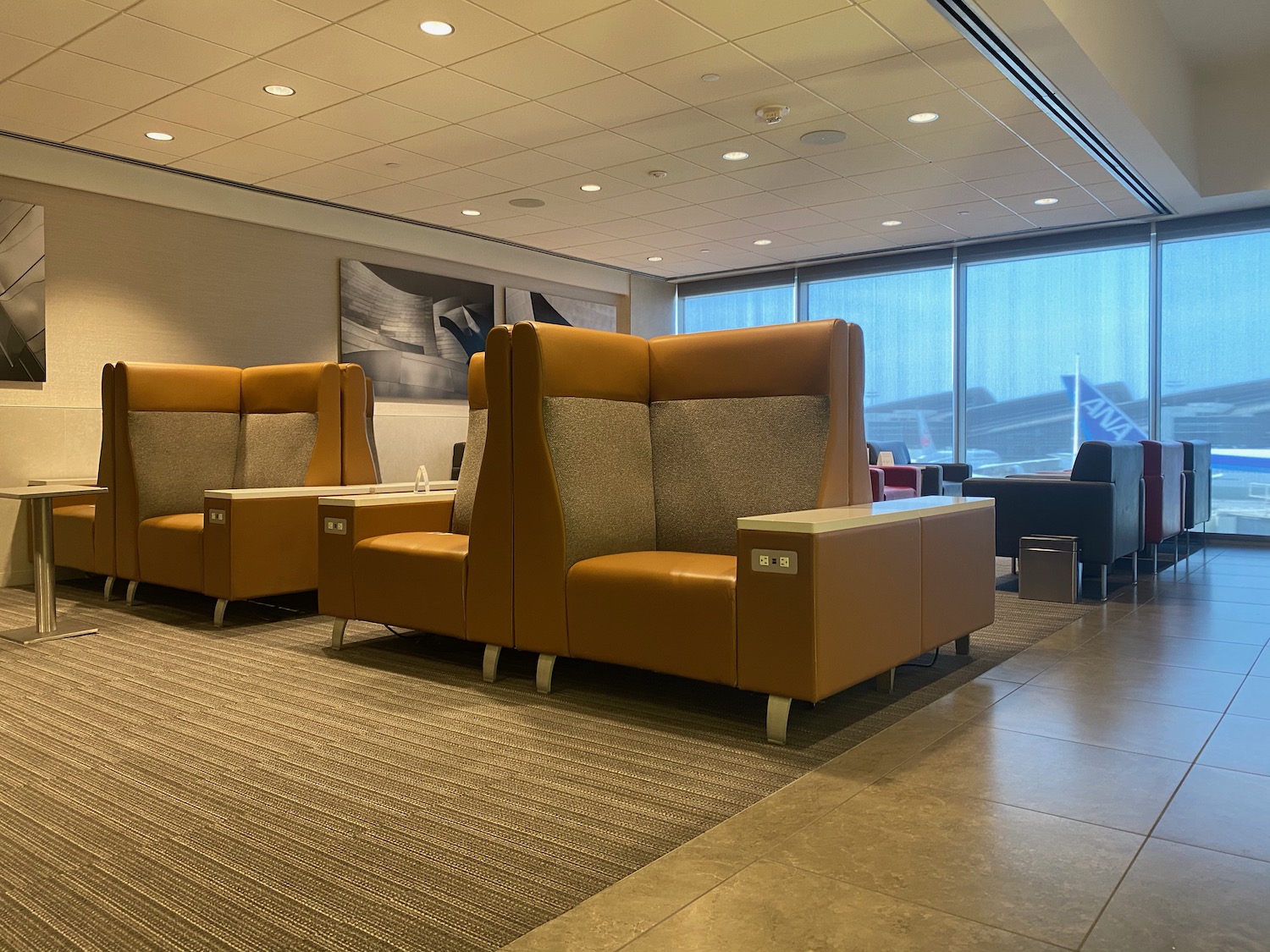 a lounge area with chairs and tables