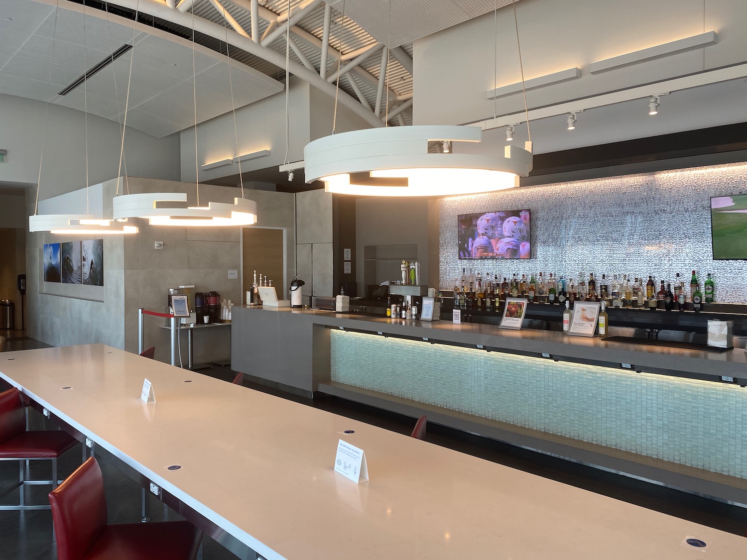 a bar with many bottles and a television on the wall