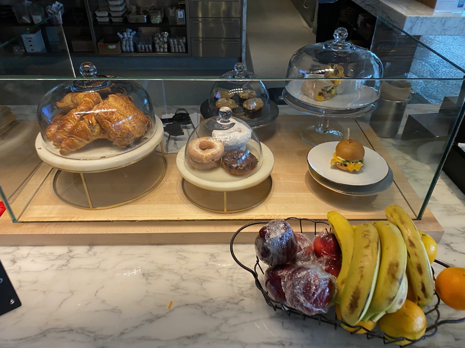 a display case with pastries and fruits