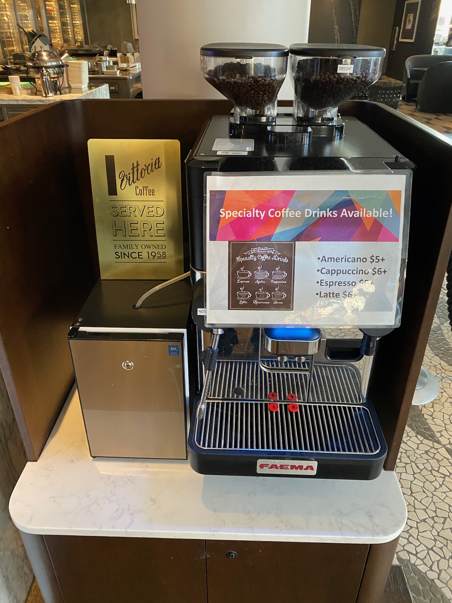 a coffee machine with a sign and a box