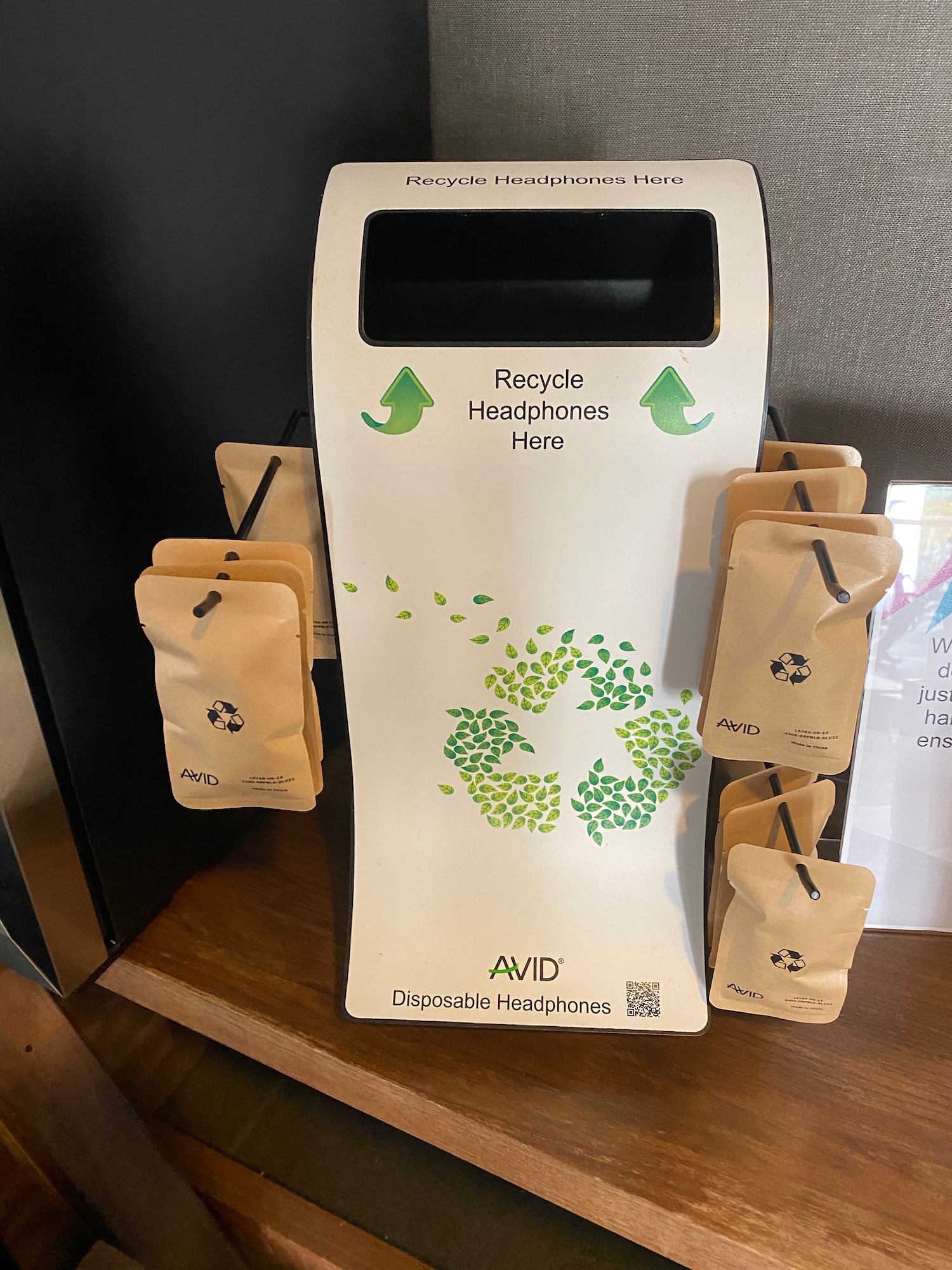 a white recycle headphones dispenser